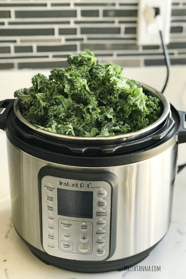 An instant pot filled with kale