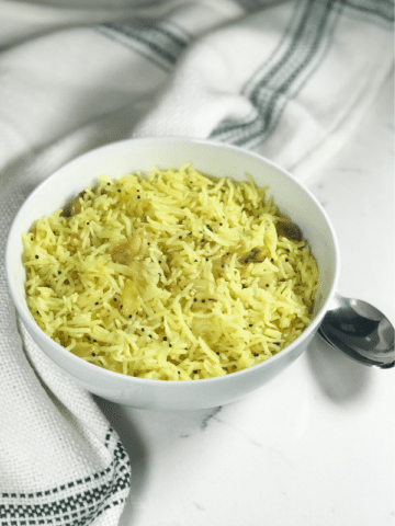 A bowl of food, with garlic rice