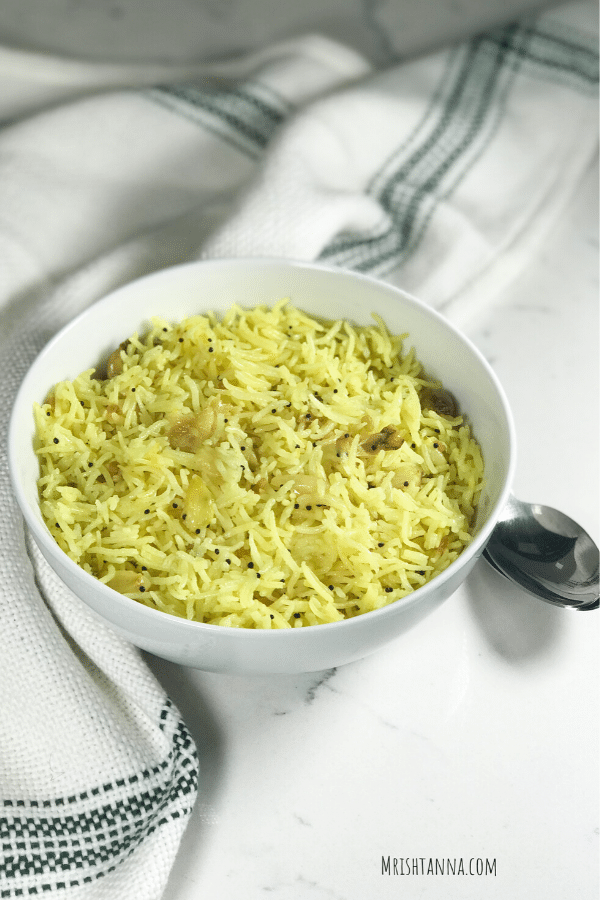 A bowl of food, with garlic rice