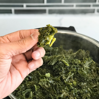 A man showing steamed Kale