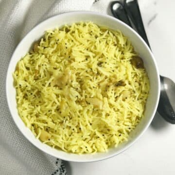 A bowl of garlic rice is on the table.