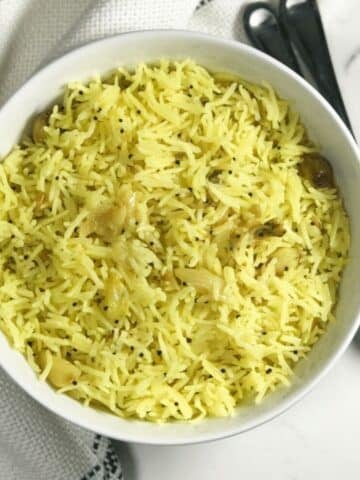 A bowl of garlic rice is on the table.