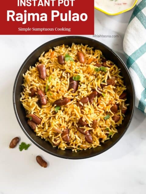 A bowl of rajma pulao and raita is on the table.