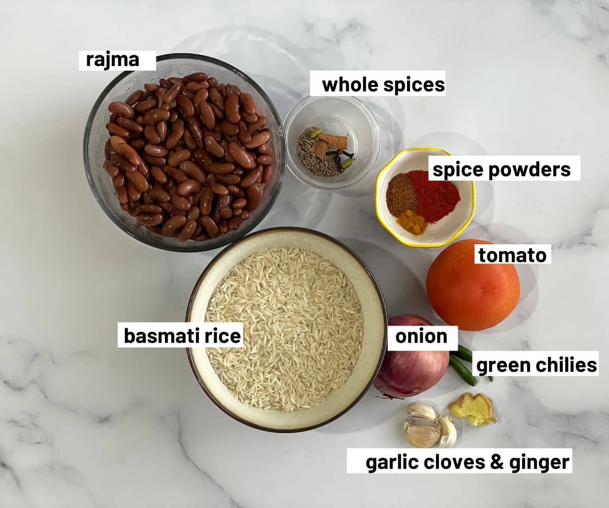 A table is covered with rajma pulao ingredients.