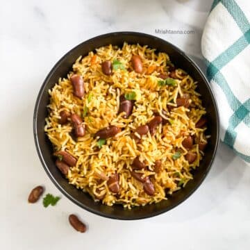 A bowl of instant pot rajma pulao is on the table.