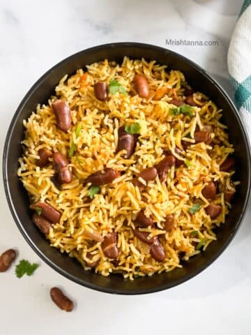 A bowl of instant pot rajma pulao is on the table.