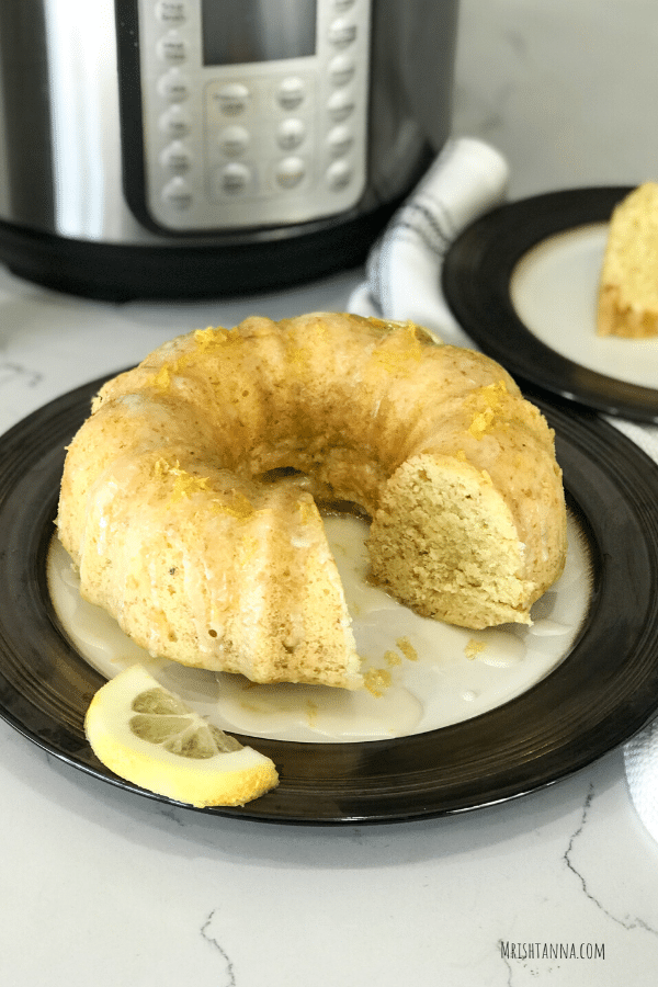 A sliced cake on a table, and drizzle glaze on top with  Lemon