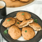 A plate of food on a table, with Puri and Mangalore buns