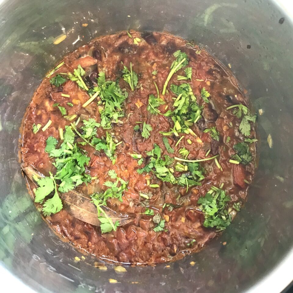 A bowl of food sitting on a pan, with Rajma and Kidney bean