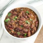 A bowl of kidney beans curry and topped with cilantro