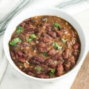 A bowl of kidney beans curry and topped with cilantro