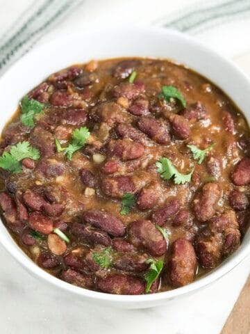 A bowl of kidney beans curry and topped with cilantro