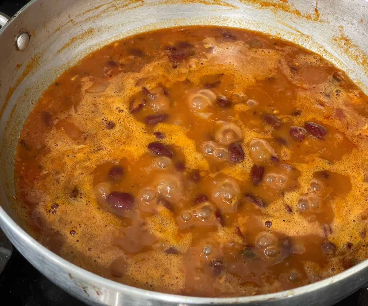 A pot is with rajma curry over the heat.