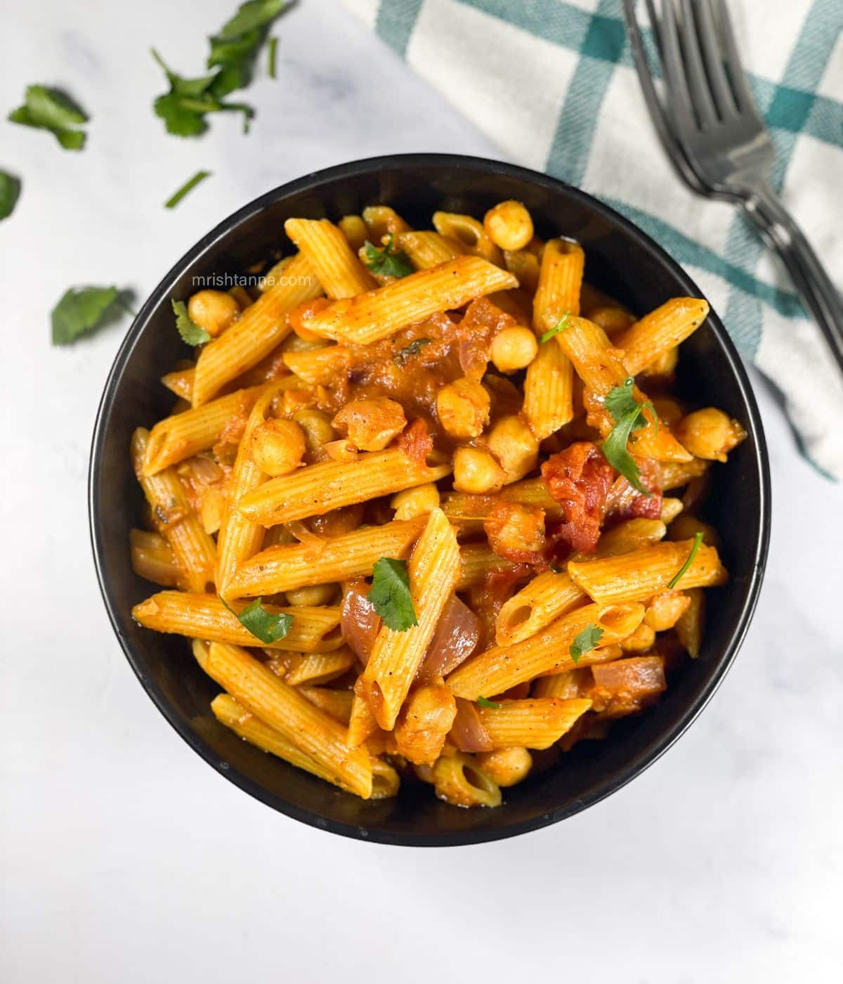 A bowl is full of tikka masala pasta.