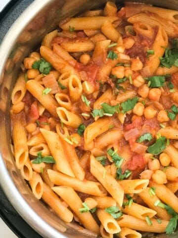 An instant pot is with tikka masala pasta on the surface