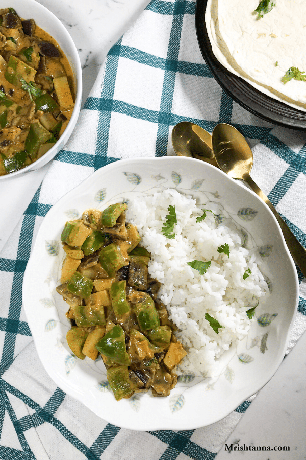 A plate of food on a table, with Curry and Potato