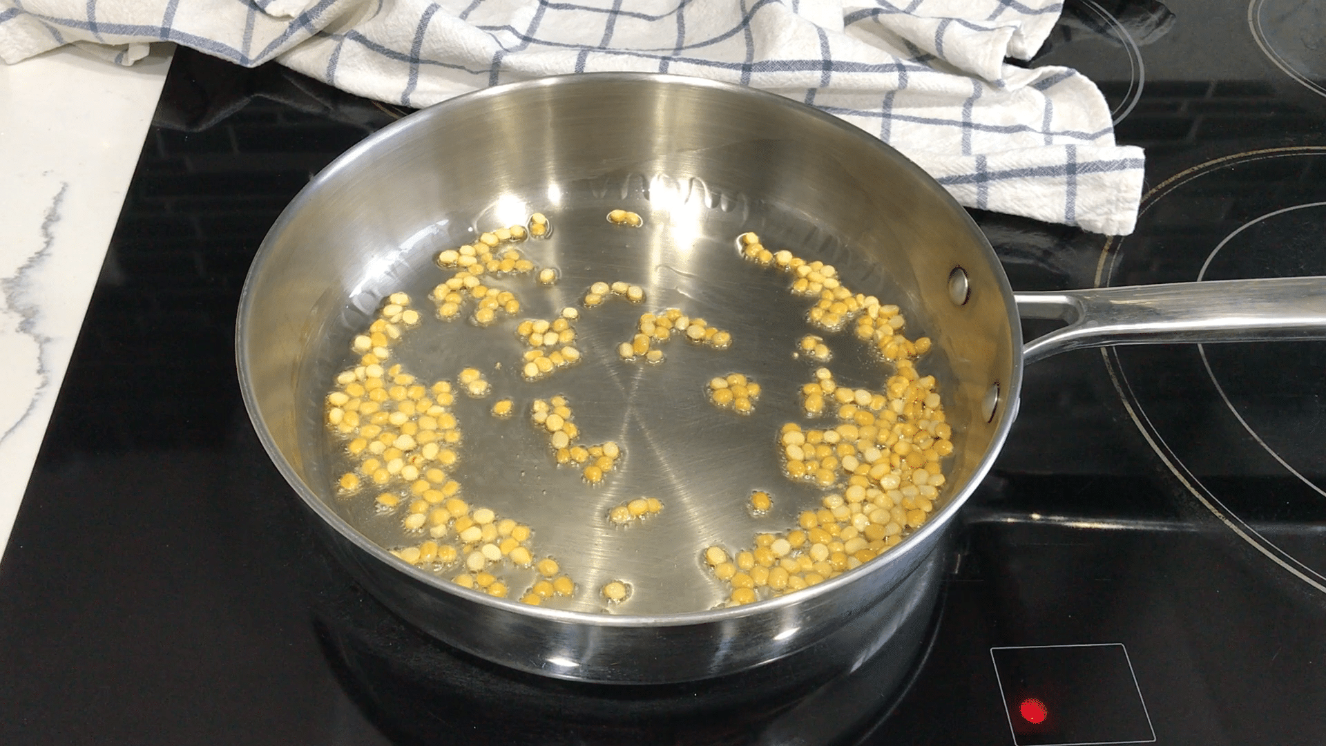 A pan on the stovetop with oil and spices