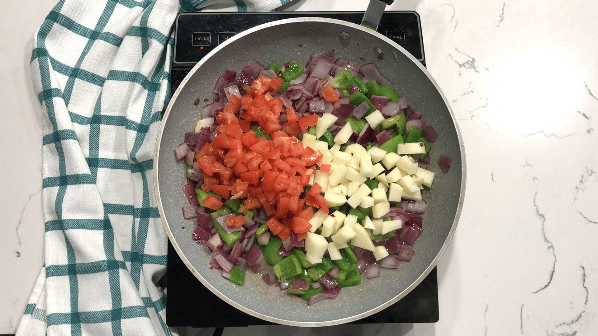 A pan of food with Curry and Potato