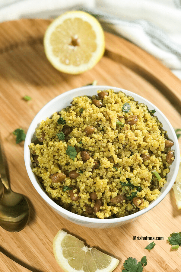 A plate of food sitting on top of a wooden table, with Quinoa and Lemon
