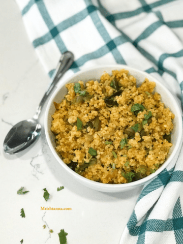 A bowl of food on a plate, with Millet and Upma