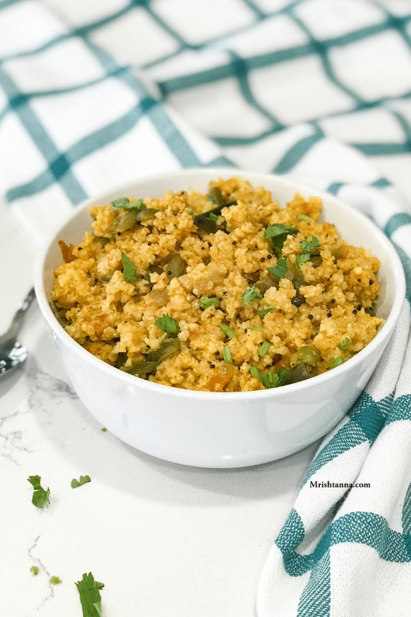 A bowl of millet with Indian spices and vegetables. 