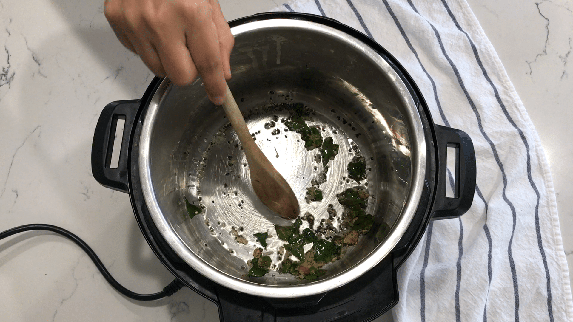 A close up of a pan on a stove, with Dal and Chayote