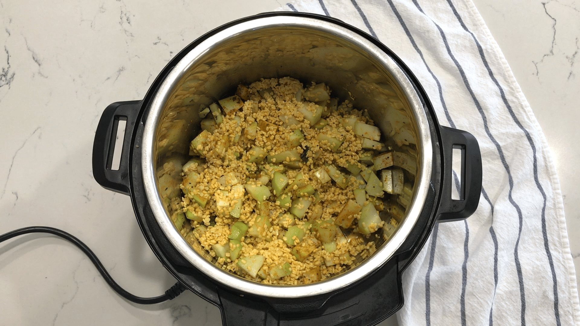 A bowl of food, with Dal and Chayote