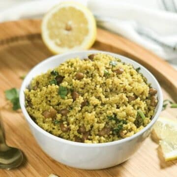 A bowl is with lemon quinoa and topped with cilantro.