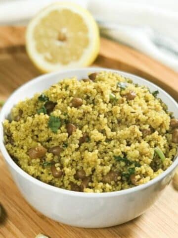 A bowl is with lemon quinoa and topped with cilantro.