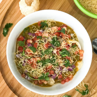 A bowl of food on a plate, with Chaat and Masala puri