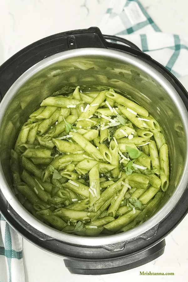 An instant pot is with vegan pesto pasta