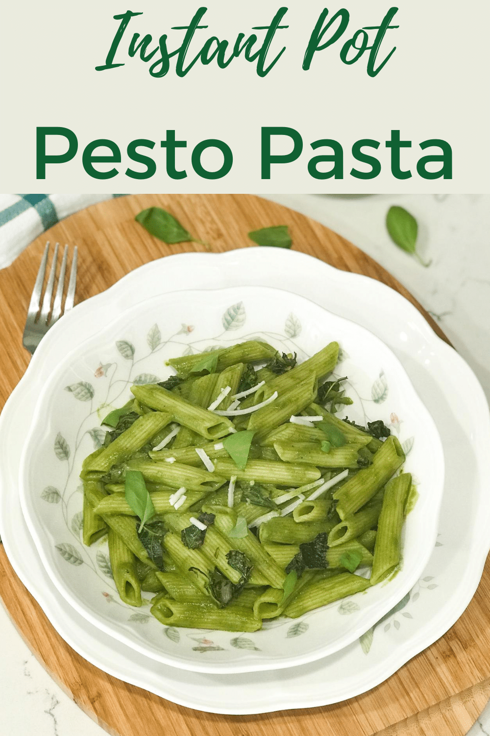 A plate of food with basil, with Pasta and Pesto