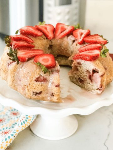 A piece of cake on a plate, with Strawberry cake