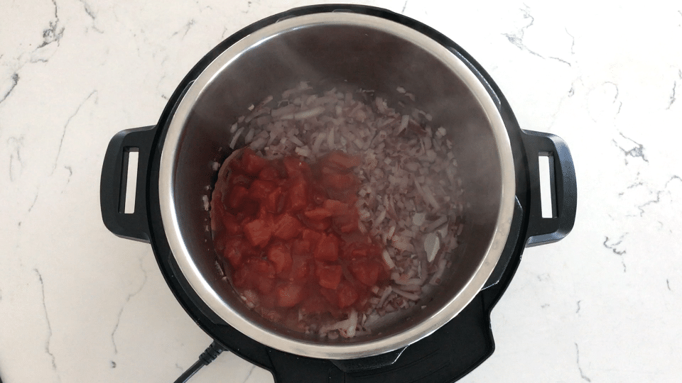 A bowl of onions, and tomatoes, with Chana masala