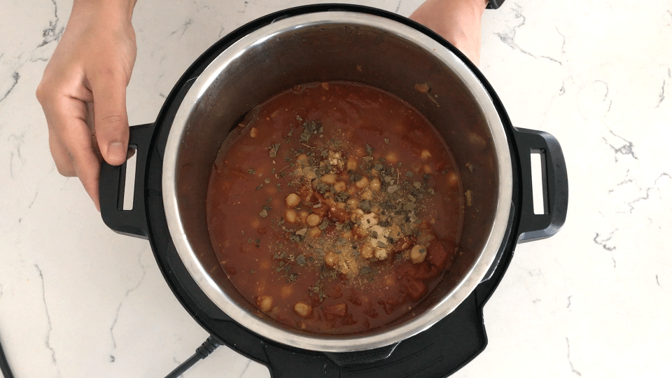A bowl of curry on a stove, with Chana masala and Gravy