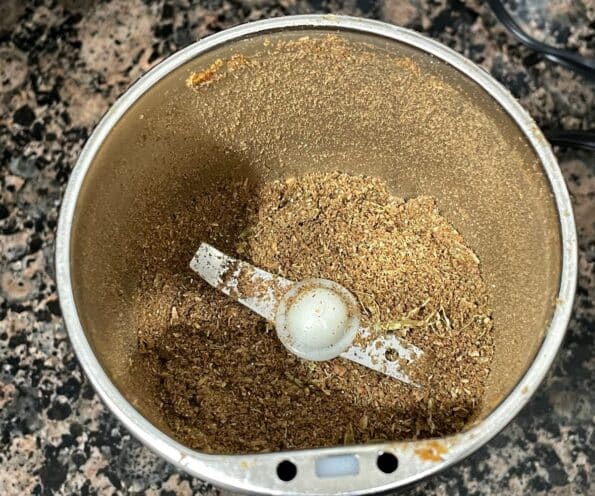 A coffee grinder is with chana masala spice mix.