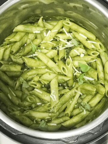 A pot is with vegan pesto pasta.
