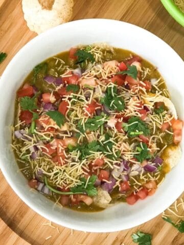 A bowl of masala puri chaat is on the table.