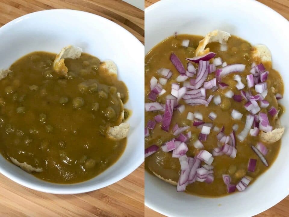 A bowl is with masala puri and topped with onions