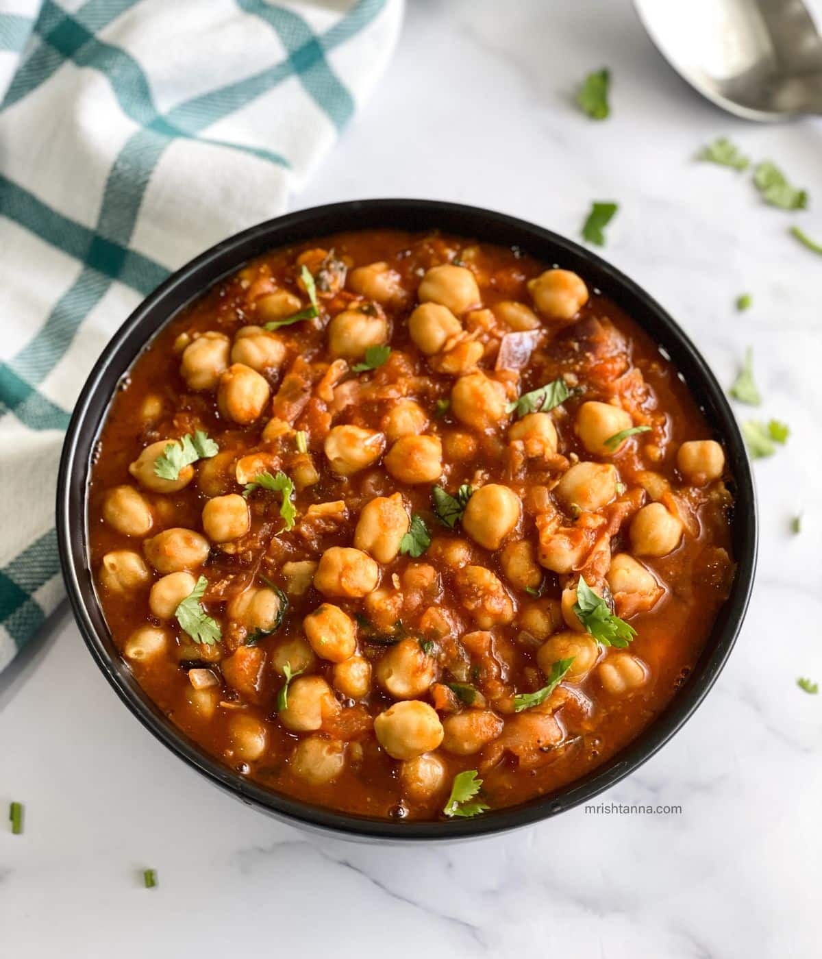 A bowl is with Vegan Chana Masala.