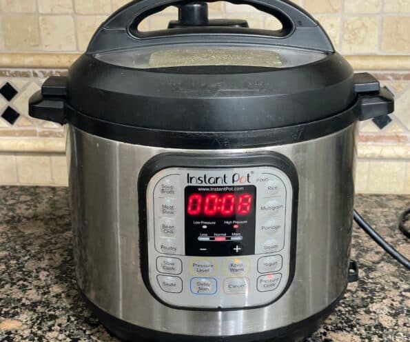 An instant pot pressure cooker is showing cooking time.