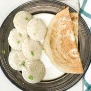 Millet idli placed on big plate with, dosa