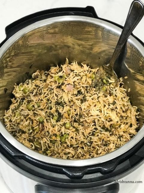 instant pot filled with rice and fork