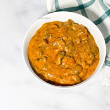 A bowl of Instant pot mushroom masala curry is on the table.