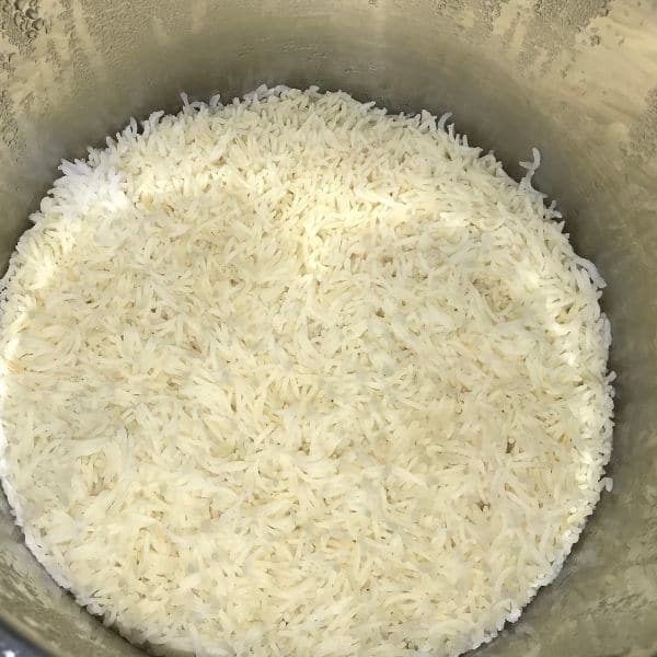 An instant pot is filled with cooked basmati rice