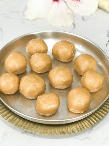 A silver plate filled with moong laddu's