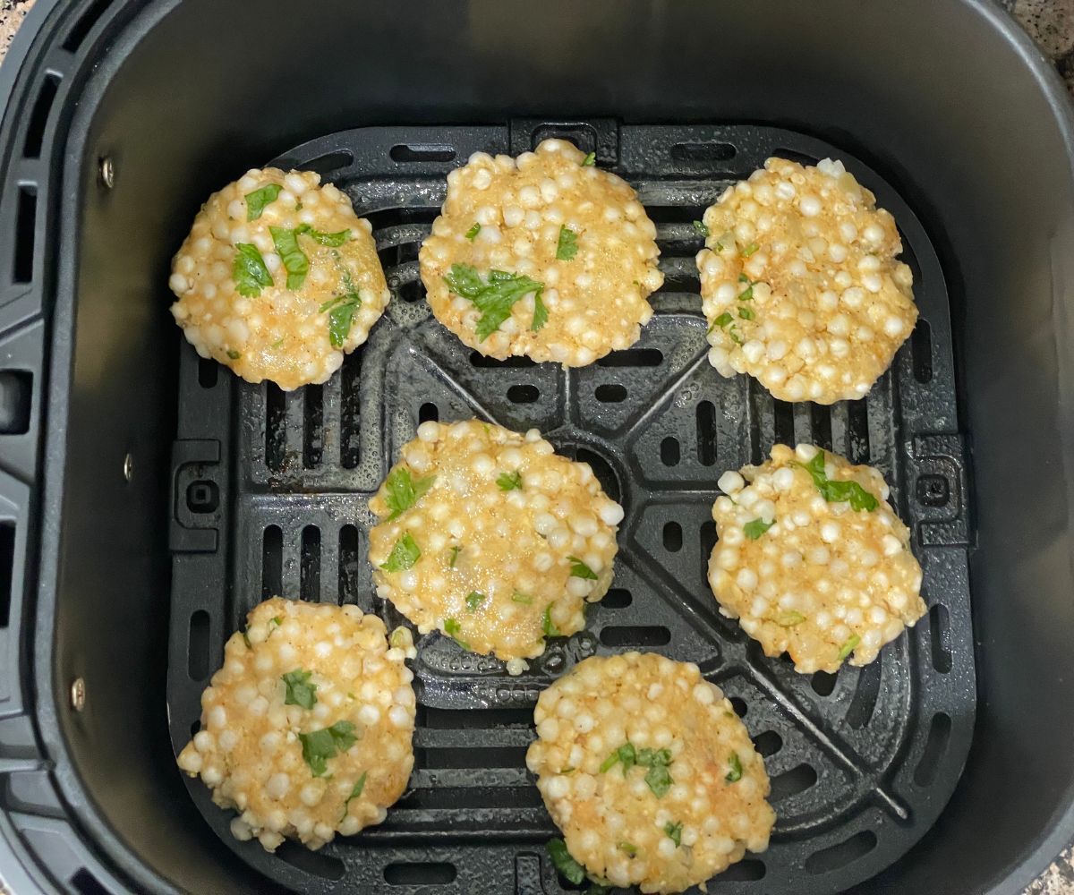 Air fryer basket is with sabudana vadas.