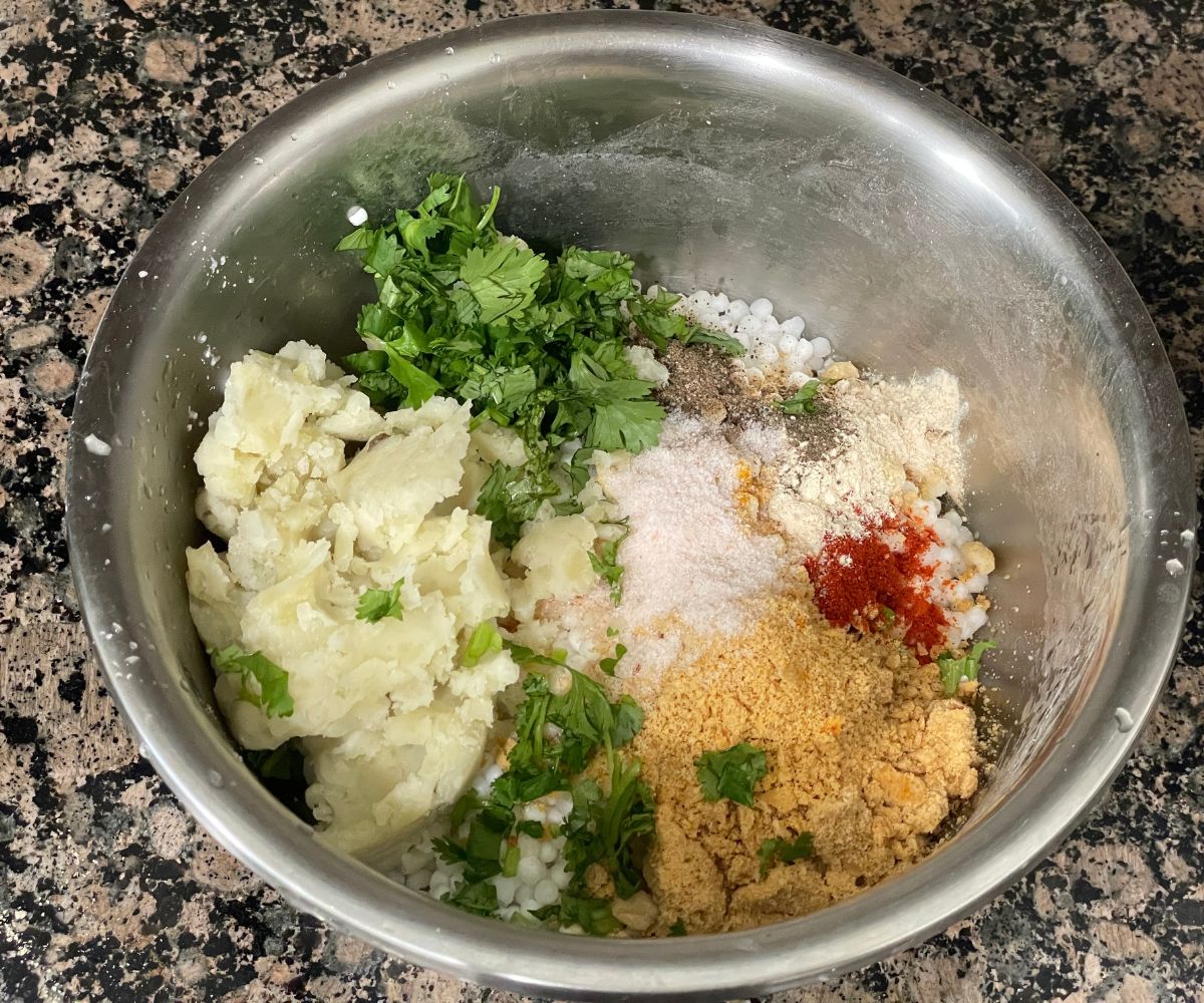 A bowl is with sabudana vada mixture.
