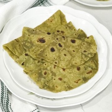 Avocado paratha is placed on a white plate