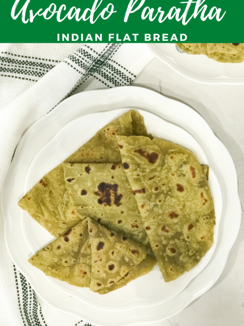 A white plate is filled with avocado parathas